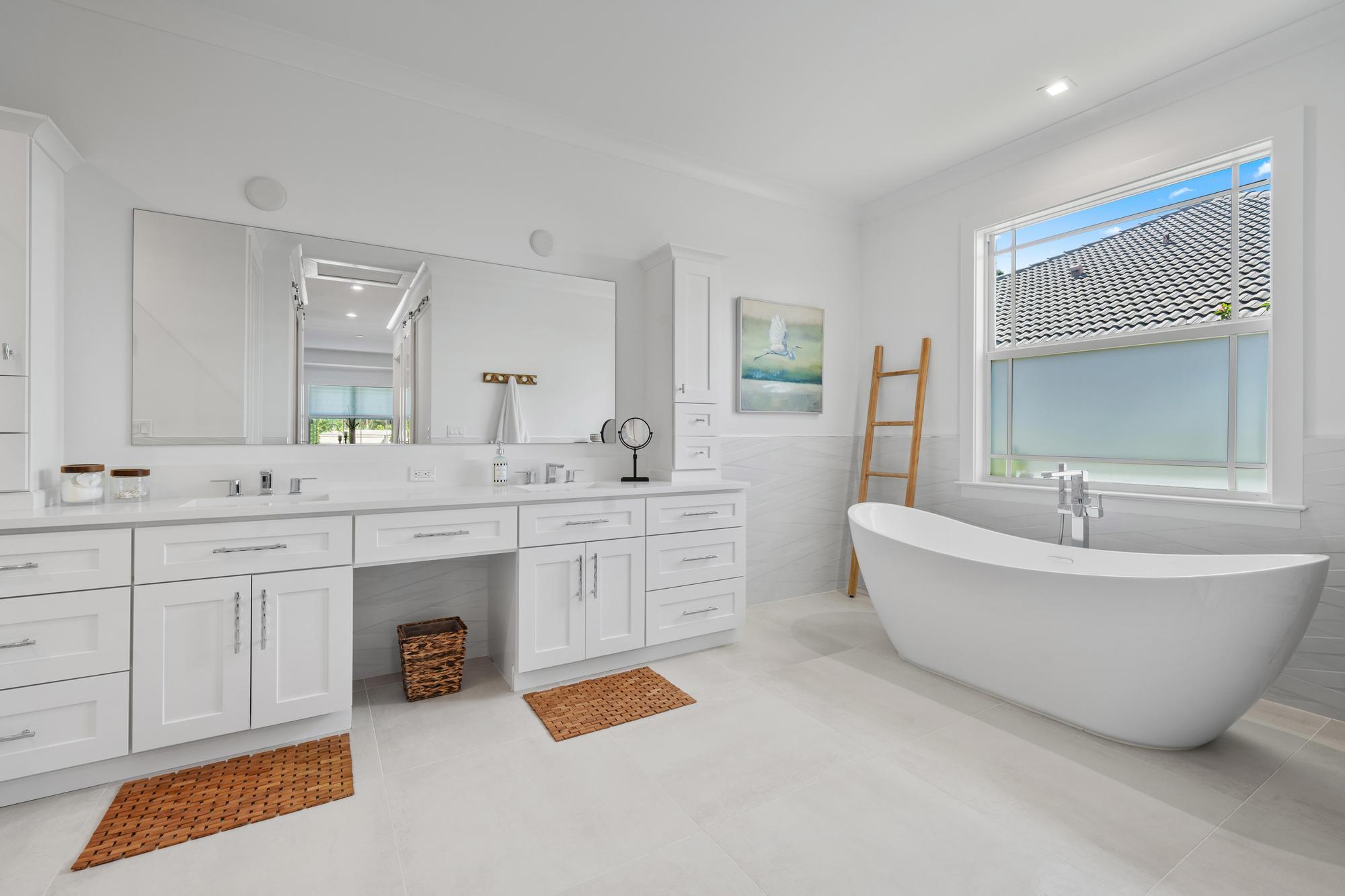 19993 Loxahatchee Pointe Drive Jupiter, FL 33458 - Photo 19 of 42 a spacious bathroom with a double vanity sink mirror and bathtub