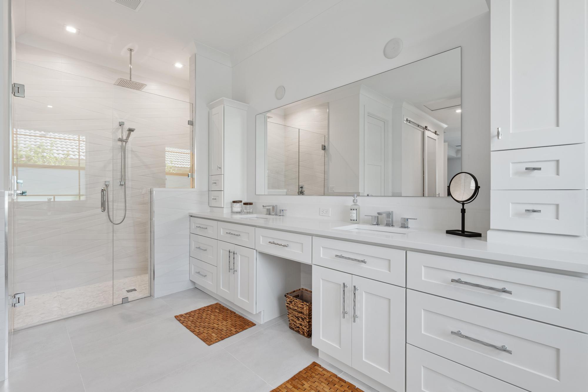 19993 Loxahatchee Pointe Drive Jupiter, FL 33458 - Photo 21 of 42 a spacious bathroom with a shower sink and a mirror