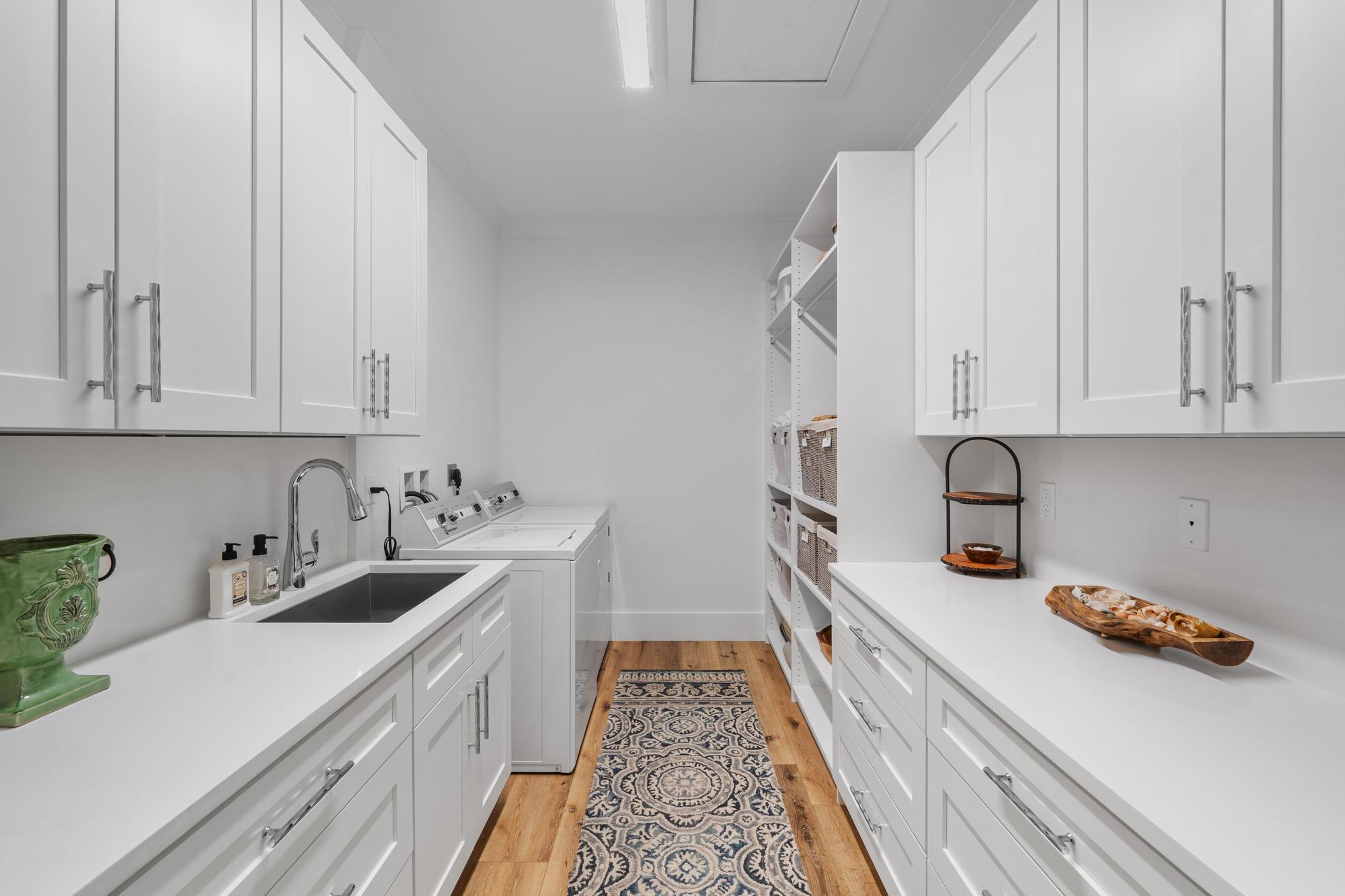 19993 Loxahatchee Pointe Drive Jupiter, FL 33458 - Photo 22 of 42 a kitchen with white cabinets and sink