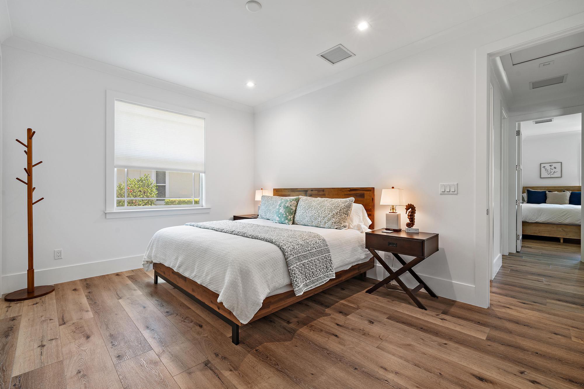 19993 Loxahatchee Pointe Drive Jupiter, FL 33458 - Photo 23 of 42 a bedroom with a bed and a view of kitchen