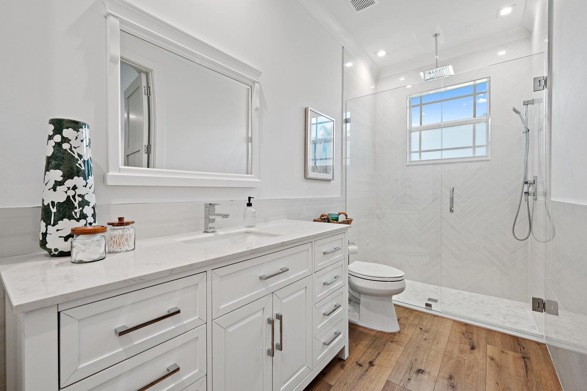 19993 Loxahatchee Pointe Drive Jupiter, FL 33458 - Photo 26 of 42 a bathroom with a double vanity sink toilet and shower