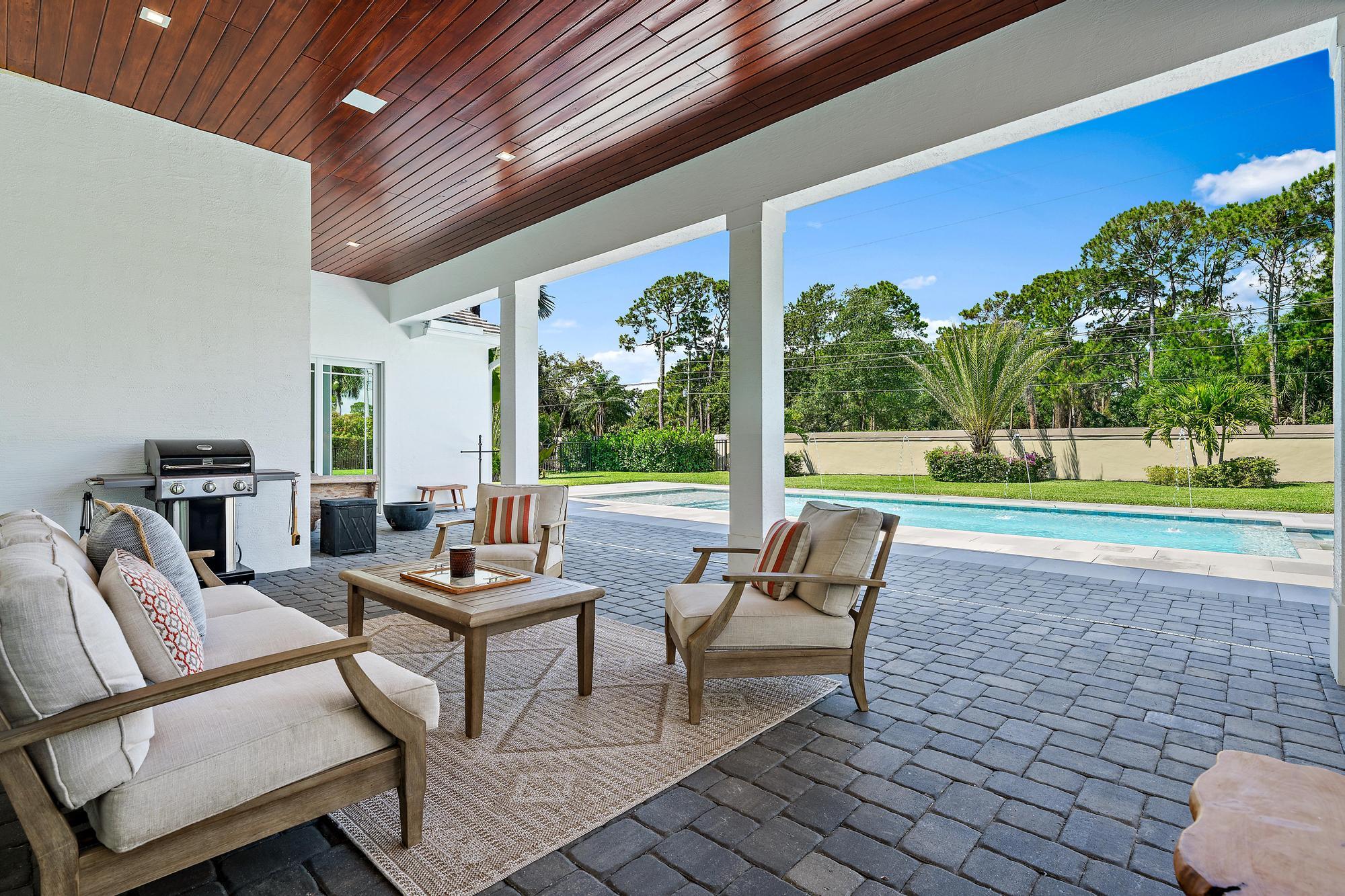 19993 Loxahatchee Pointe Drive Jupiter, FL 33458 - Photo 30 of 42 a outdoor living space with furniture and garden view
