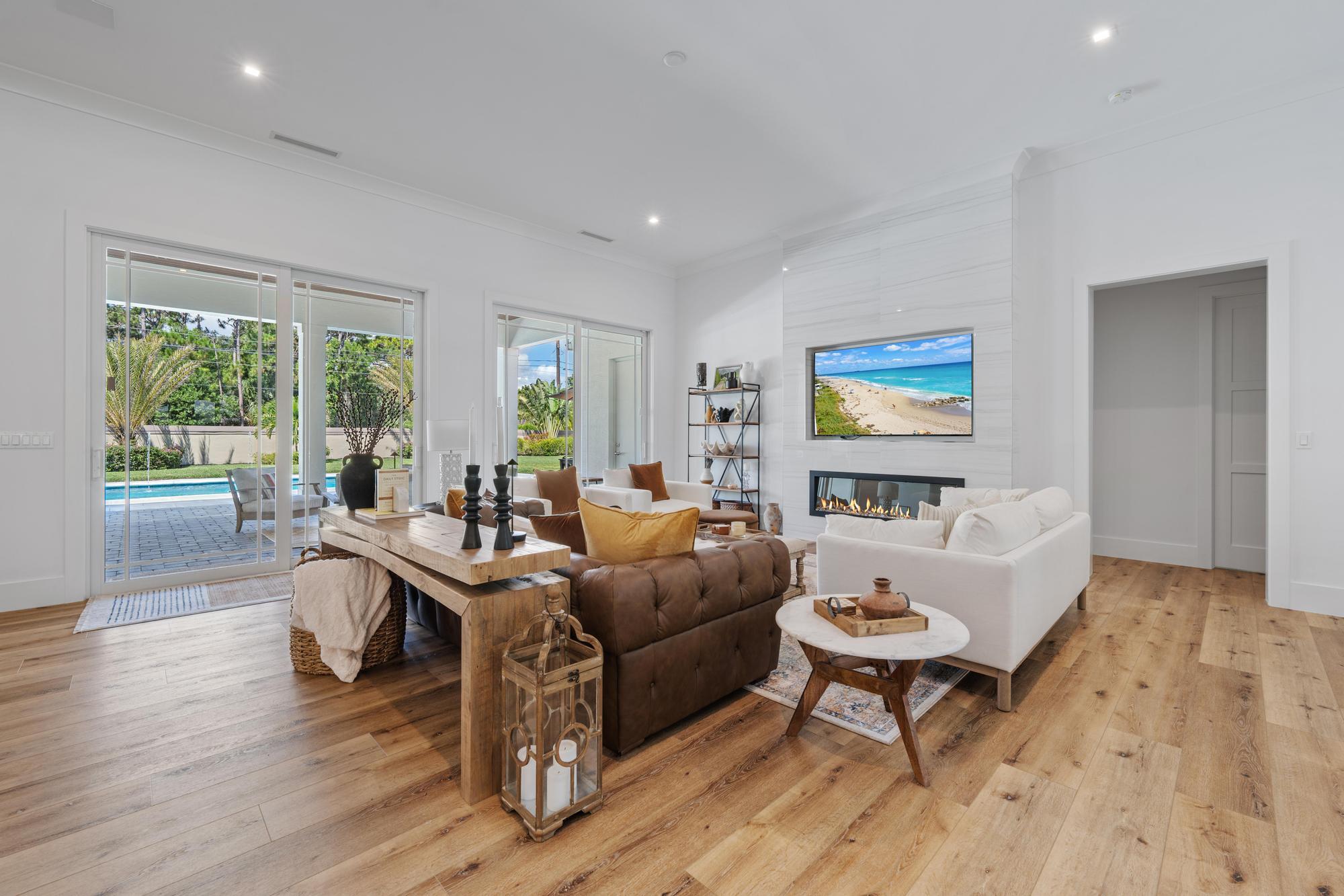 19993 Loxahatchee Pointe Drive Jupiter, FL 33458 - Photo 3 of 42 a living room with furniture a table and a large window