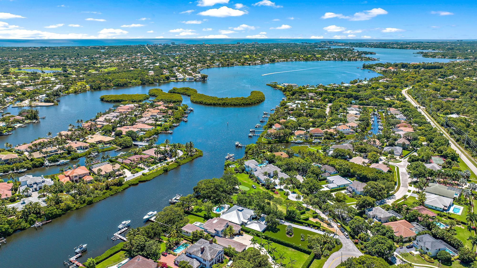 19993 Loxahatchee Pointe Drive Jupiter, FL 33458 - Photo 38 of 42 a view of a city with lots of residential buildings ocean and lots of trees