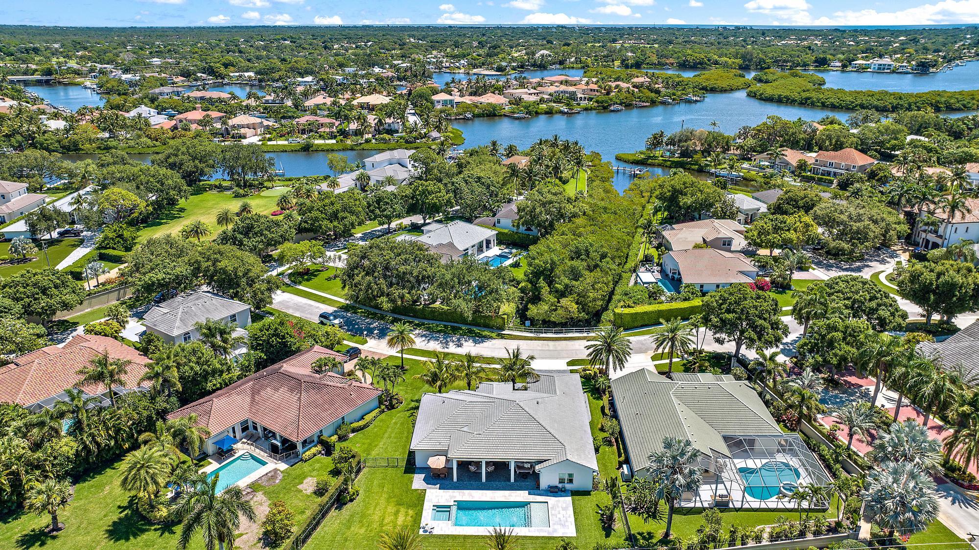 19993 Loxahatchee Pointe Drive Jupiter, FL 33458 - Photo 40 of 42 an aerial view of residential houses with outdoor space and lake view