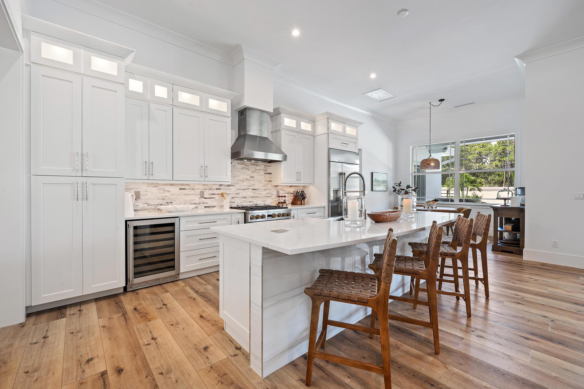 19993 Loxahatchee Pointe Drive Jupiter, FL 33458 - Photo 5 of 42 a kitchen with stainless steel appliances a dining table chairs stove and cabinets