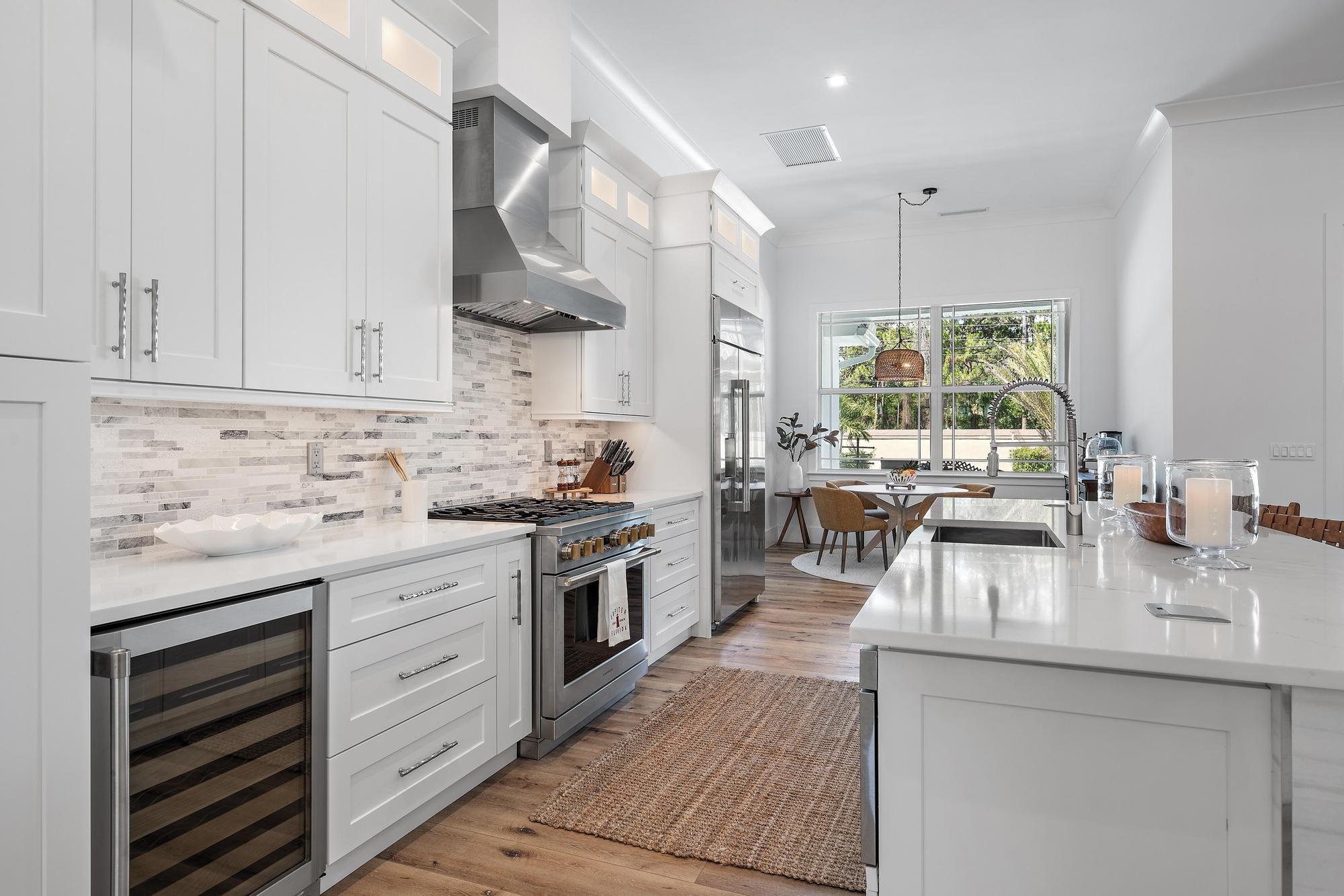 19993 Loxahatchee Pointe Drive Jupiter, FL 33458 - Photo 6 of 42 a kitchen with stainless steel appliances granite countertop a sink stove and cabinets