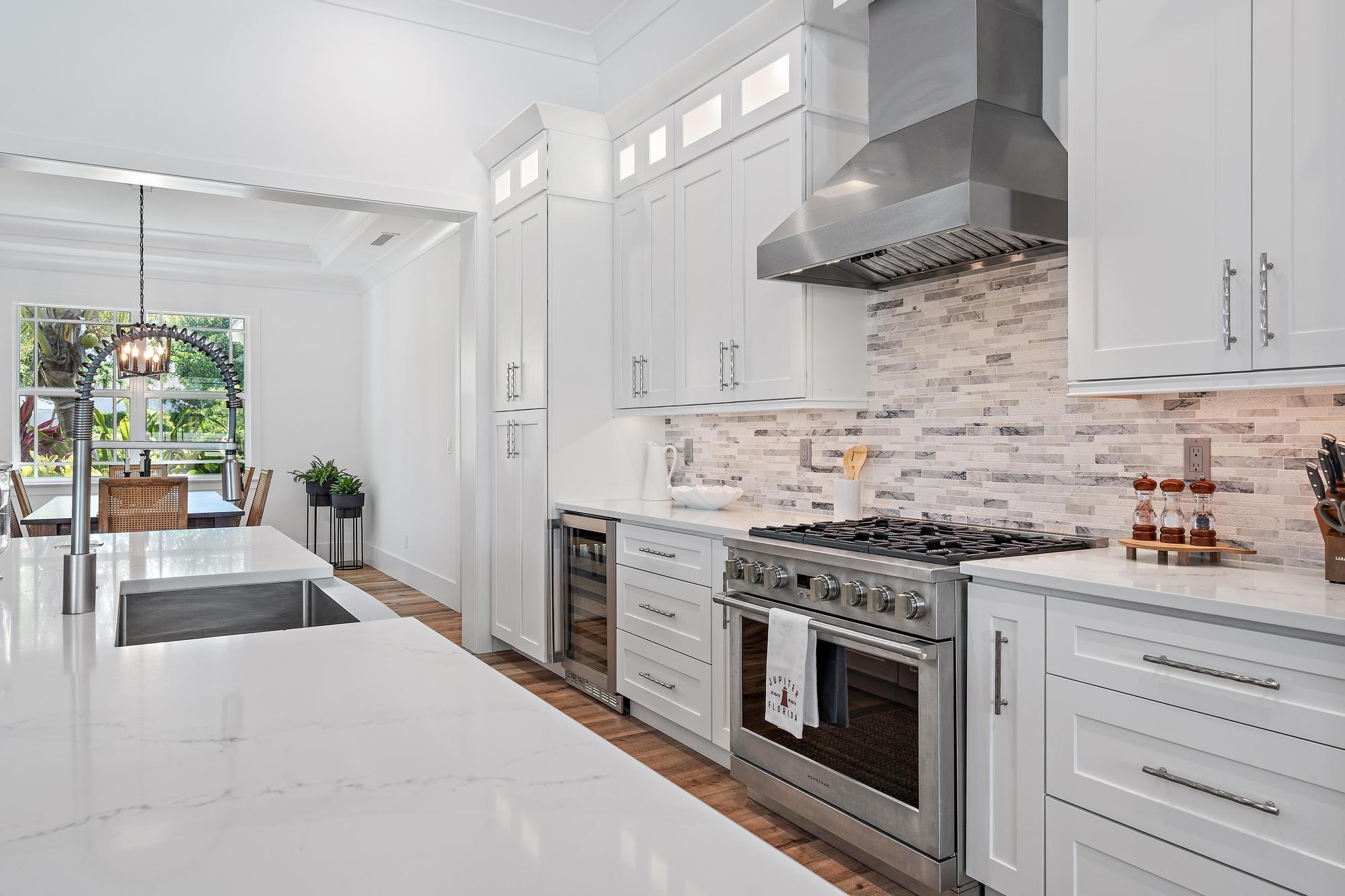 19993 Loxahatchee Pointe Drive Jupiter, FL 33458 - Photo 10 of 42 a kitchen with stainless steel appliances white cabinets and a stove