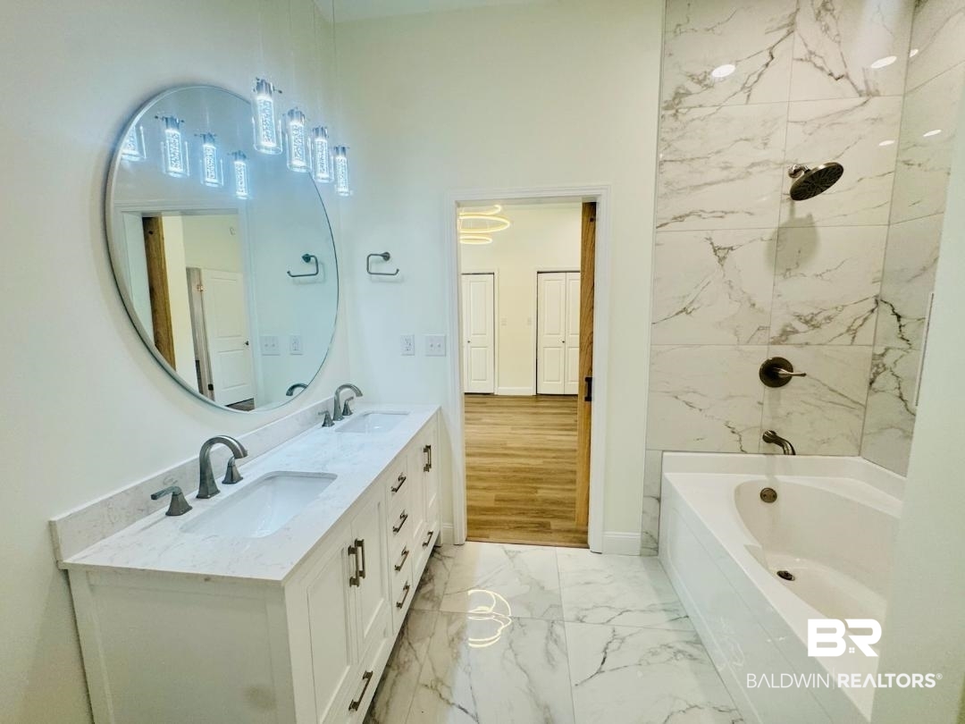 2663 Demetropolis Road Mobile, AL 36693 - Photo 14 of 26 Bathroom featuring marble look tile flooring, double vanity, and bathtub / shower combination