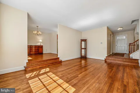 a view of a room with wooden floor and a sink