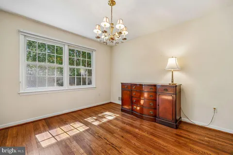 a view of wooden floor chandelier and window in a room