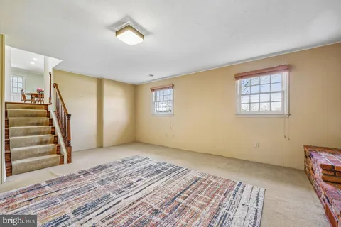 a view of an empty room with a fireplace and a window