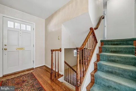 a view of entryway with wooden floor and stair