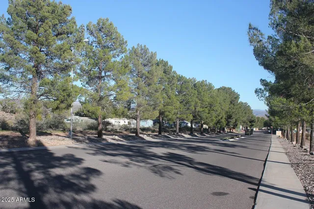 a view of a swimming pool and lounge chairs in the patio