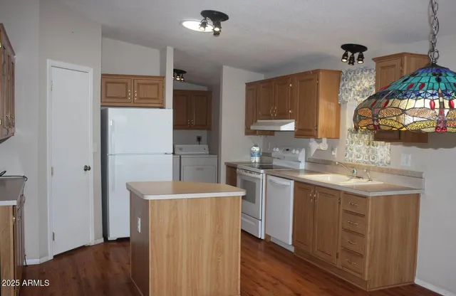 a kitchen with sink a refrigerator and a stove