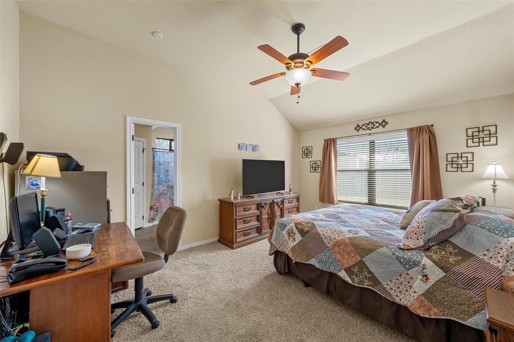900 Elizabeth Drive Robinson, TX 76706 - Photo 13 of 35 a bedroom with a bed a computer on the desk and a window