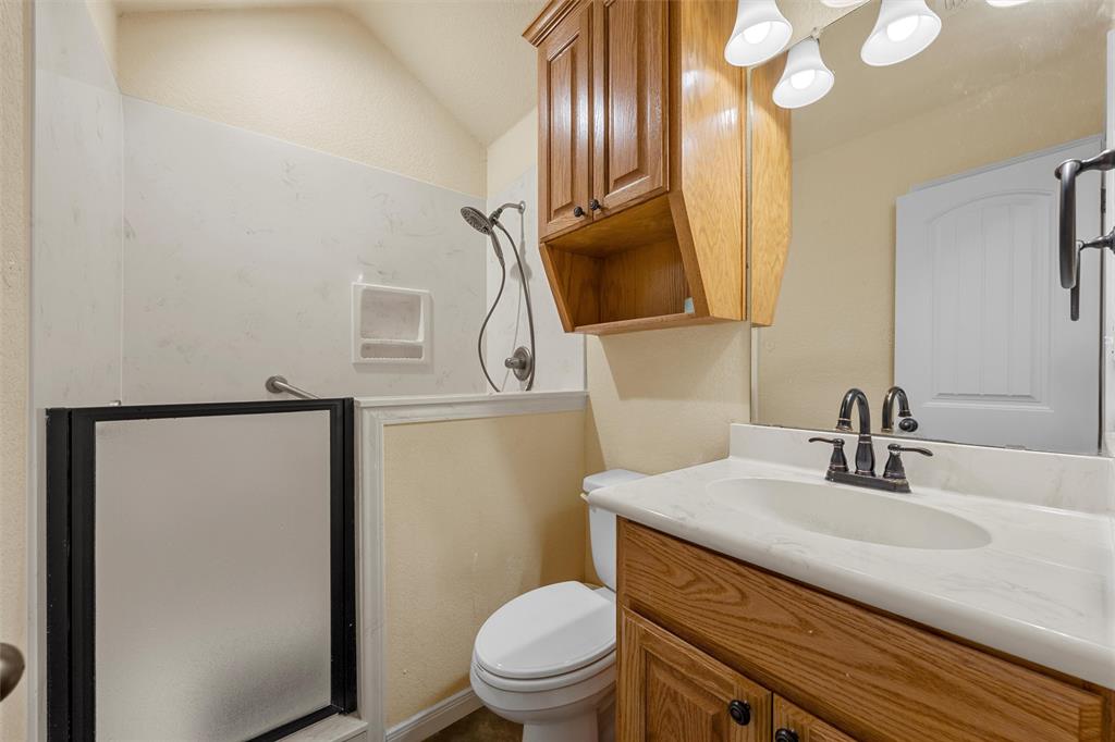 900 Elizabeth Drive Robinson, TX 76706 - Photo 20 of 35 a bathroom with a granite countertop sink toilet and mirror