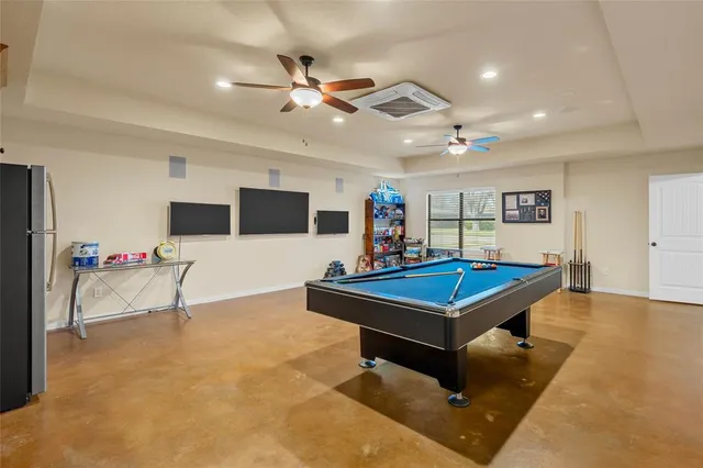 a living room with furniture pool table and flat screen tv
