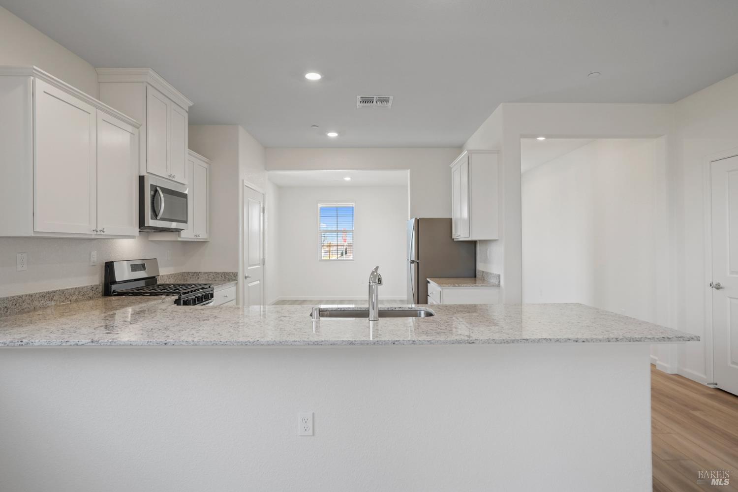 2251 Front Porch Lane Rio Vista, CA 94571 - Photo 7 of 18 a kitchen with stainless steel appliances granite countertop a sink and a stove top oven