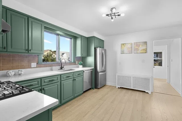 a kitchen with refrigerator and cabinets