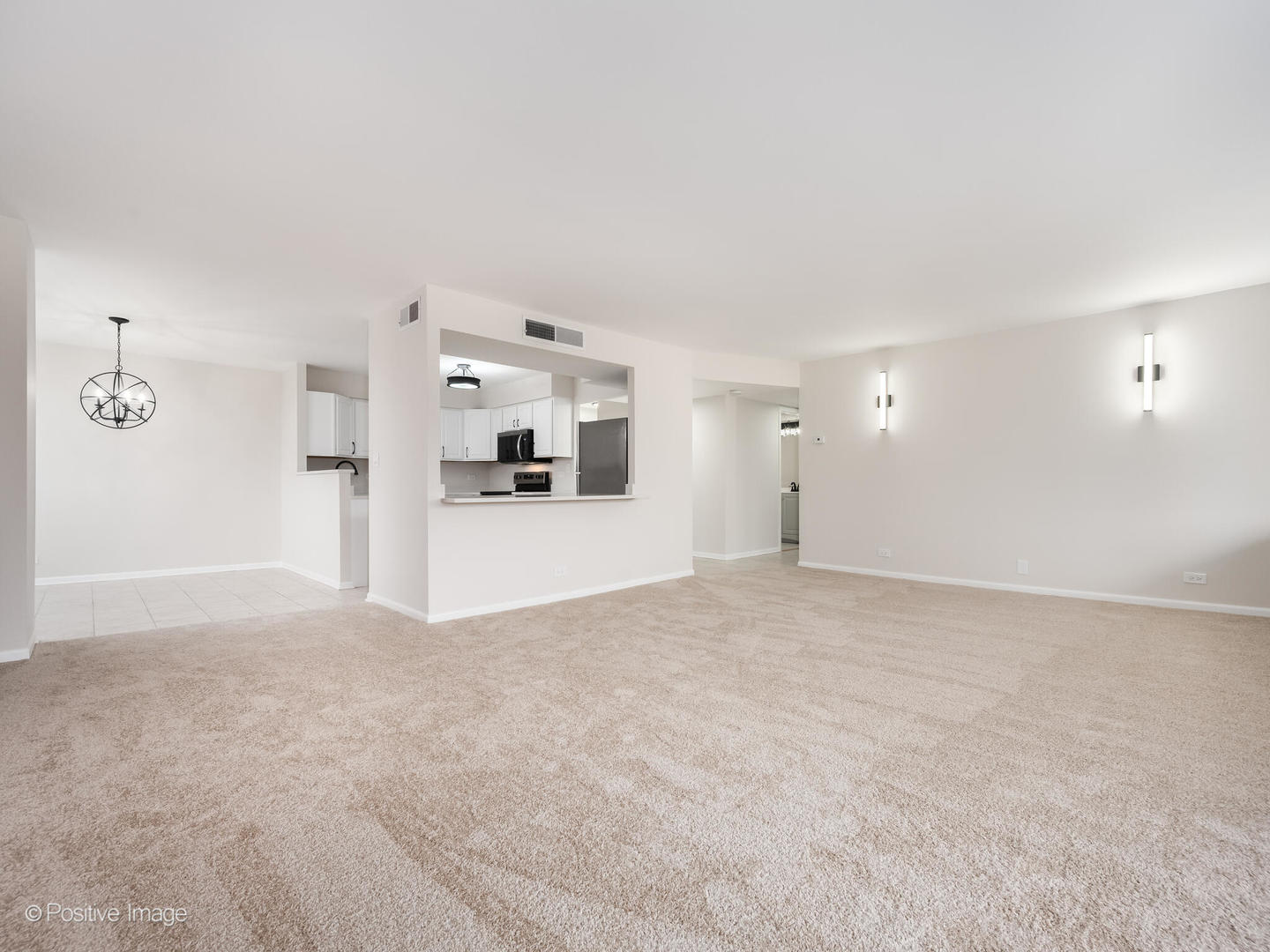 101 Bar Harbour Road, Unit 2M Schaumburg, IL 60193 - Photo 4 of 17 a view of a big room with wooden floor and a kitchen