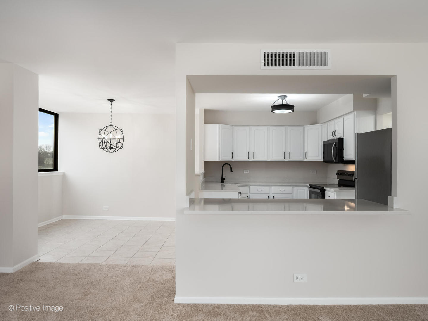 101 Bar Harbour Road, Unit 2M Schaumburg, IL 60193 - Photo 5 of 17 a kitchen with stainless steel appliances granite countertop a sink a stove and a refrigerator
