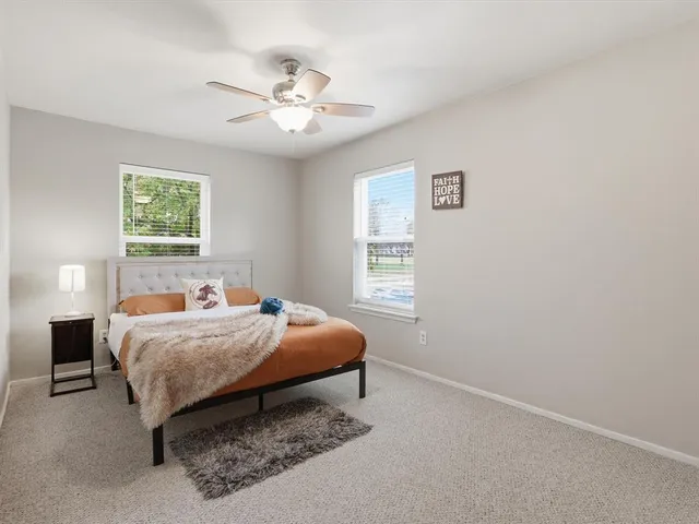 a bedroom with a bed and window