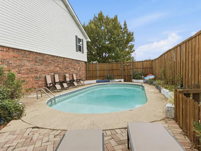 a view of a swimming pool with a patio