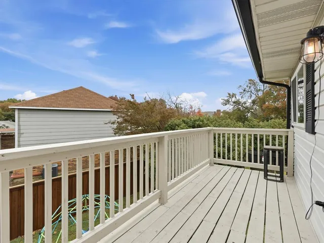 a view of a wooden deck with a yard