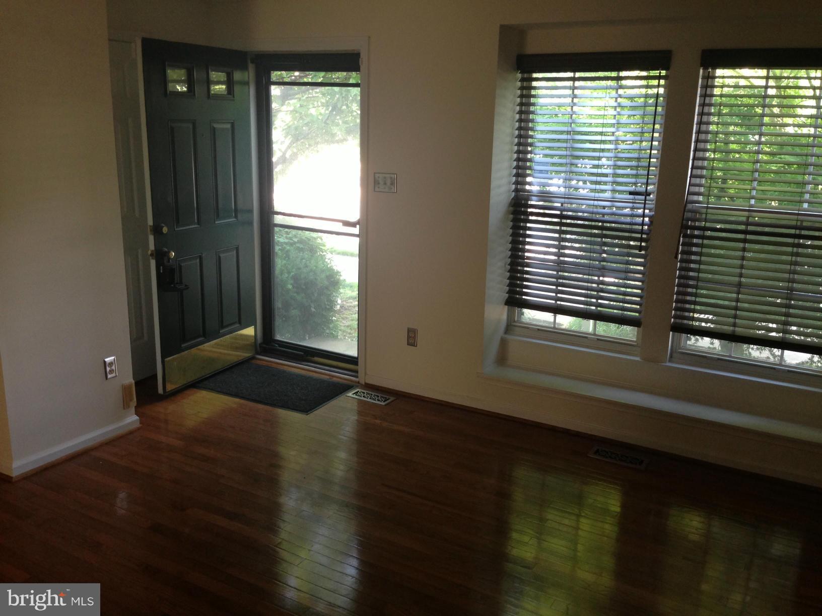 2180 South Glebe Road Arlington, VA 22204 - Photo 2 of 19 a view of an empty room with wooden floor and a window