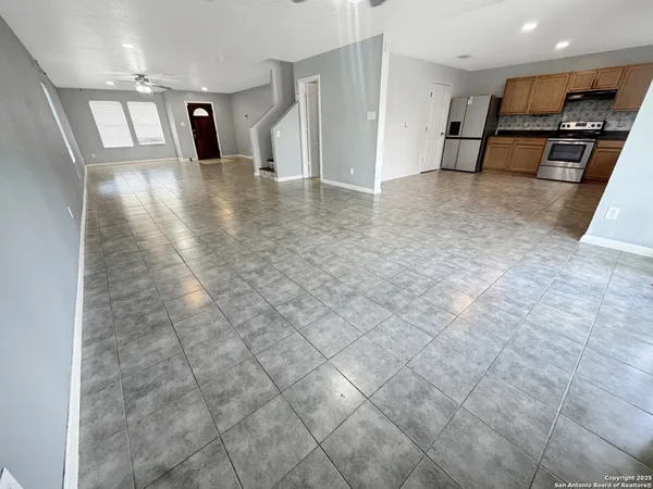 a view of a refrigerator in kitchen and a window