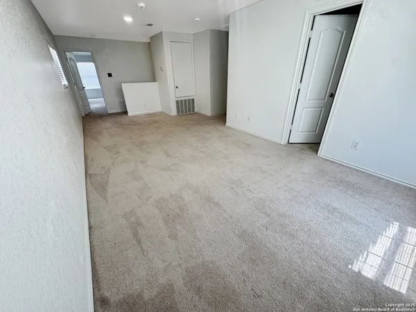 a view of a livingroom with a ceiling fan and window
