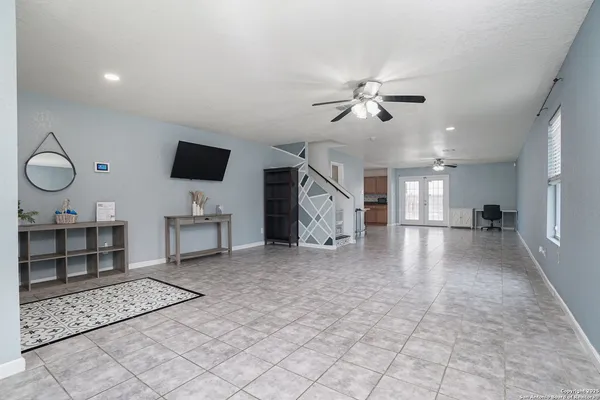 a view of a livingroom with furniture cabinets and a ceiling fan