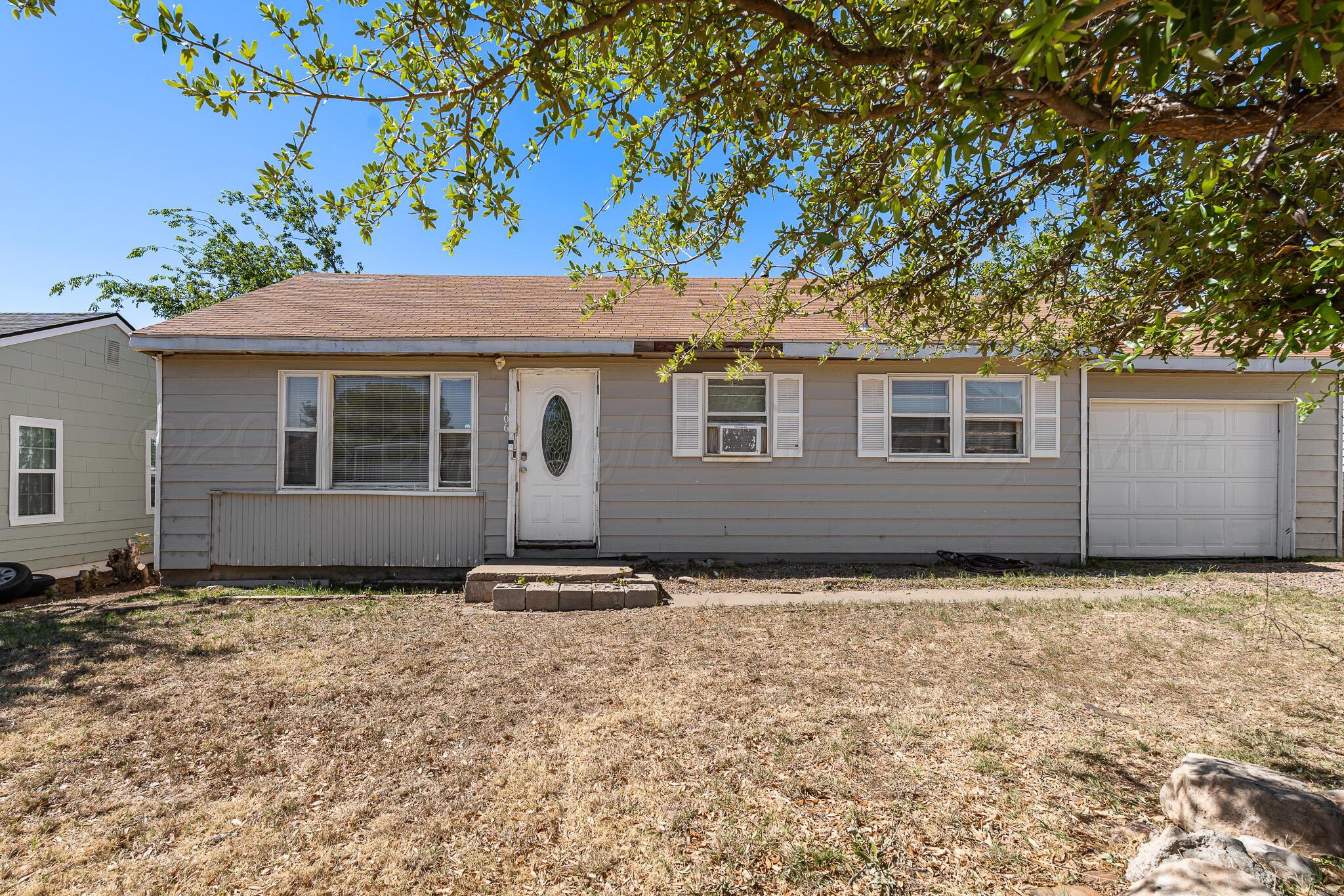 106 Peiffer Street Borger, TX 79007 - Photo 1 of 12 a house with trees in the background