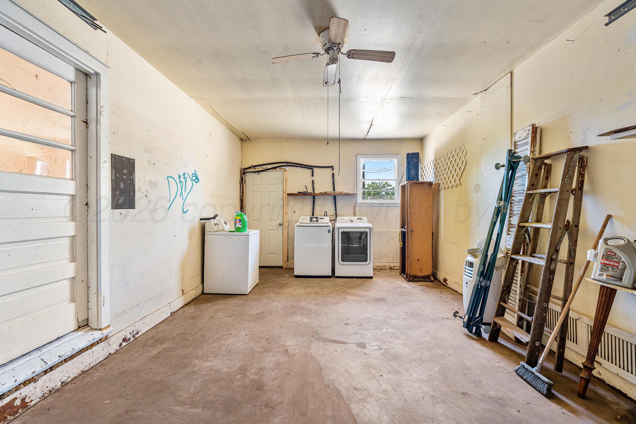 106 Peiffer Street Borger, TX 79007 - Photo 11 of 12 a view of a storage & utility room with refrigerator and windows