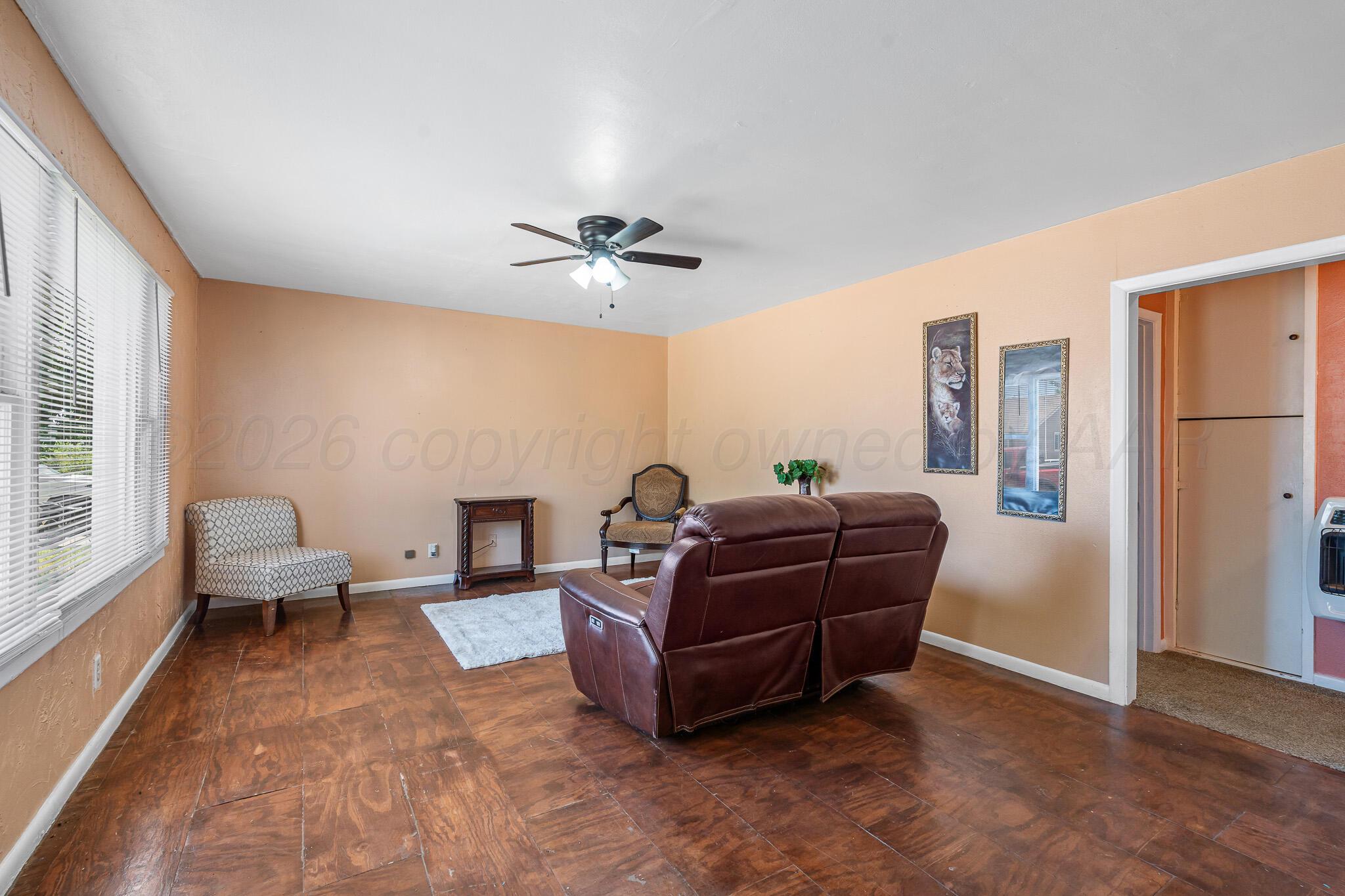 106 Peiffer Street Borger, TX 79007 - Photo 3 of 12 a living room with furniture and a chandelier