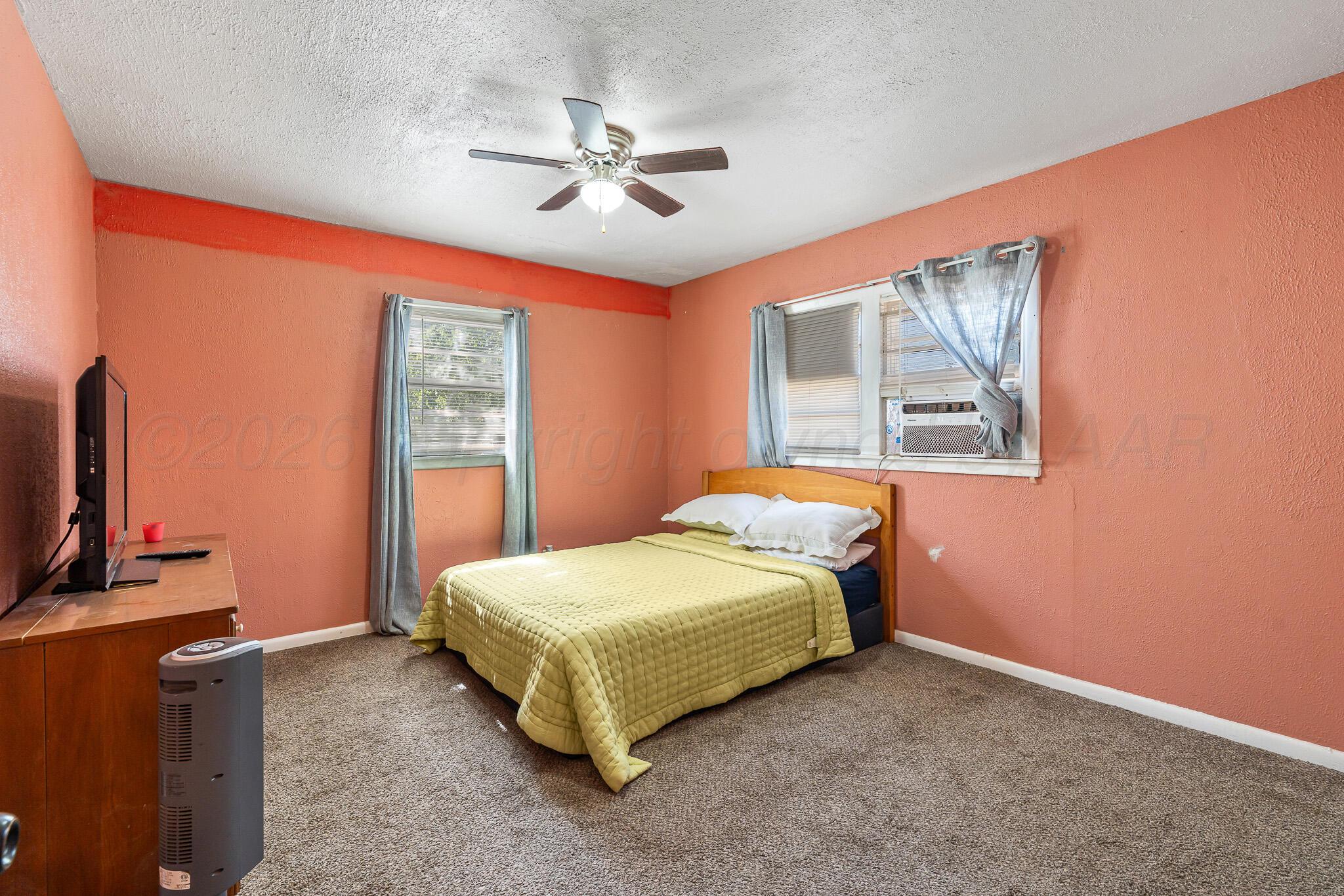 106 Peiffer Street Borger, TX 79007 - Photo 5 of 12 a bedroom with a bed and a flat screen tv