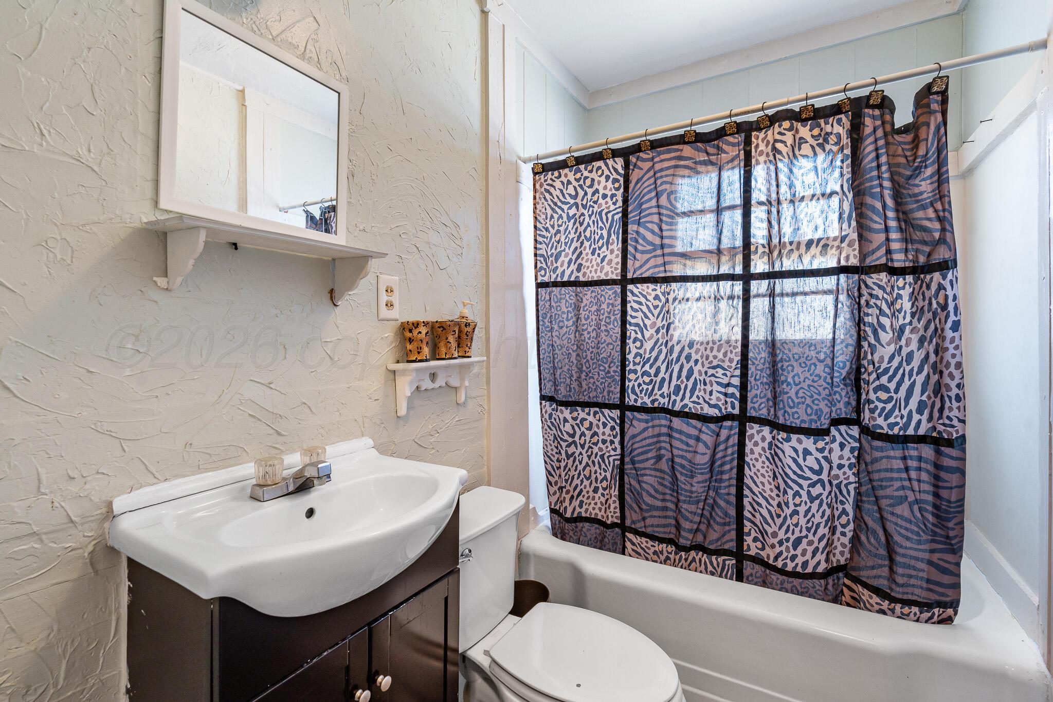 106 Peiffer Street Borger, TX 79007 - Photo 6 of 12 a bathroom with a sink toilet and shower