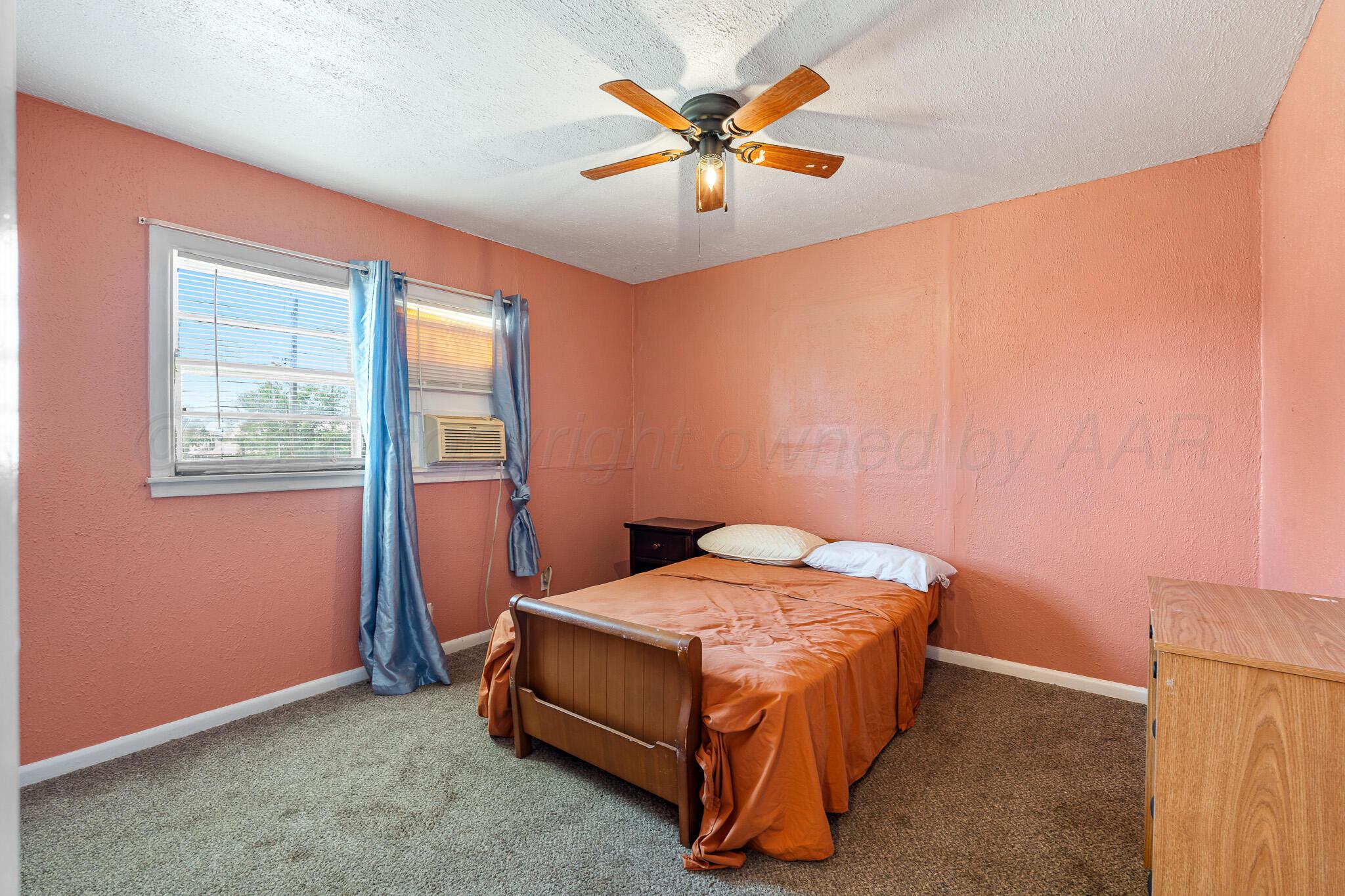 106 Peiffer Street Borger, TX 79007 - Photo 7 of 12 a bed sitting in a bedroom next to a window