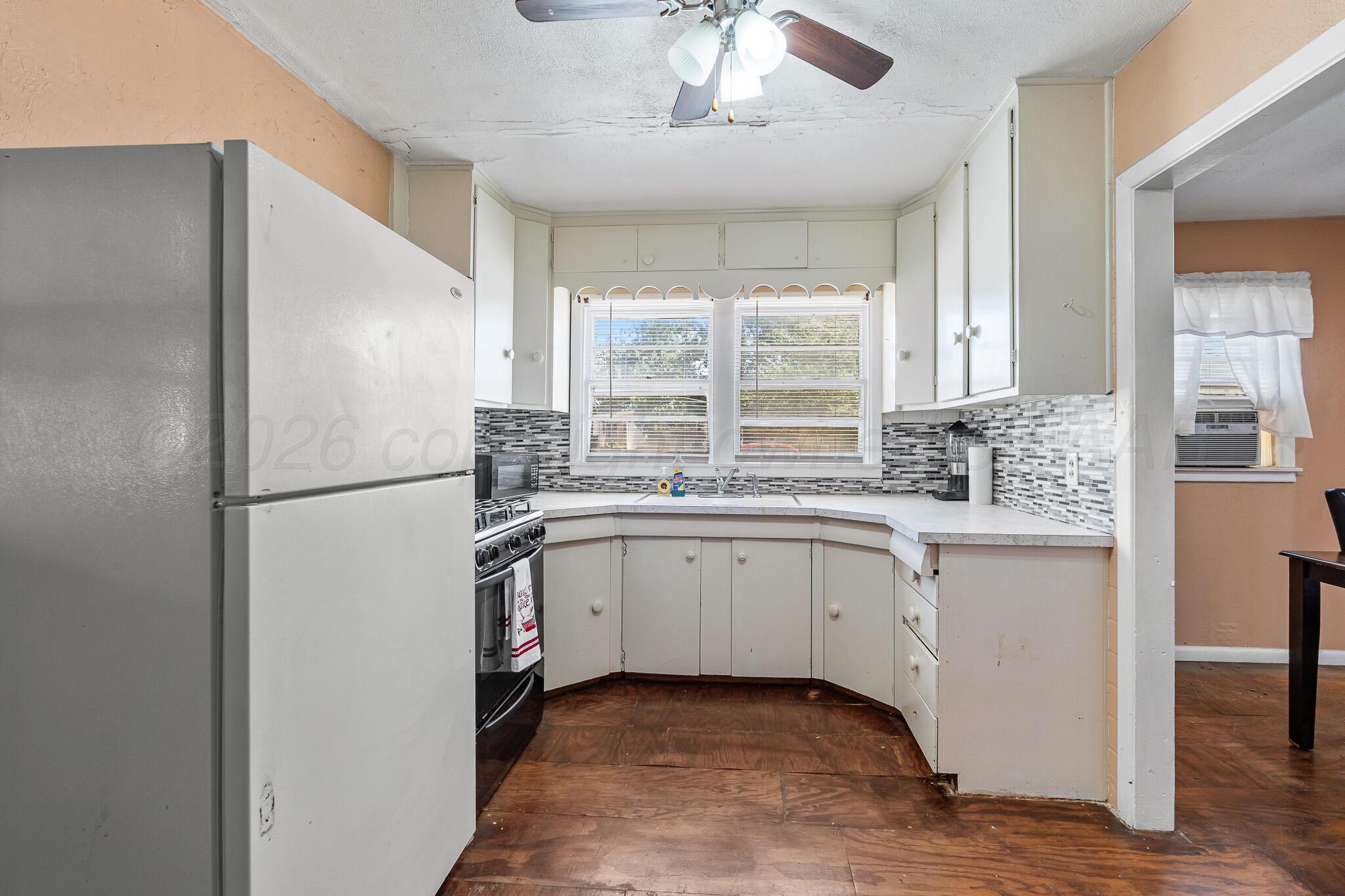 106 Peiffer Street Borger, TX 79007 - Photo 10 of 12 a kitchen with a refrigerator sink and cabinets