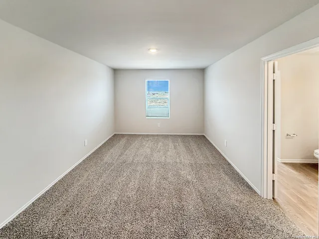 a view of a backyard with wooden fence