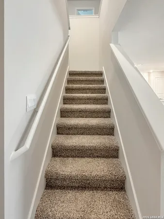 a view of staircase with white walls