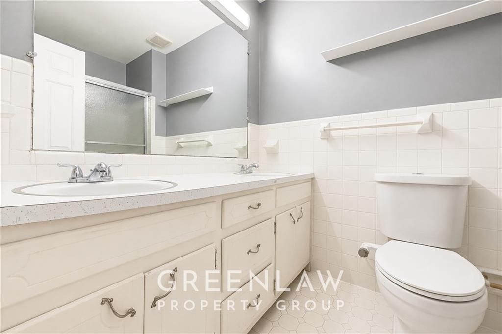 3605 Flat Shoals Road Atlanta, GA 30349 - Photo 23 of 35 a bathroom with a sink a toilet and a mirror