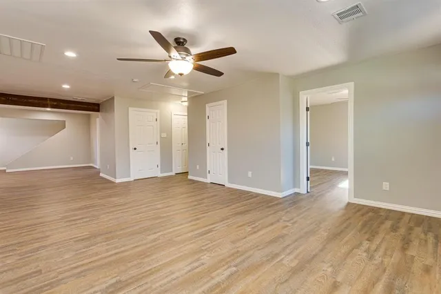 a view of an empty room and wooden floor