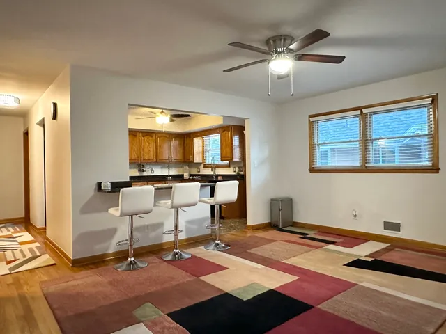 a kitchen with stainless steel appliances granite countertop a refrigerator a stove and a sink