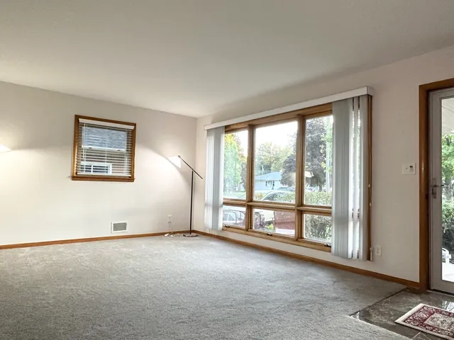 a workspace with wooden floor and a chandelier