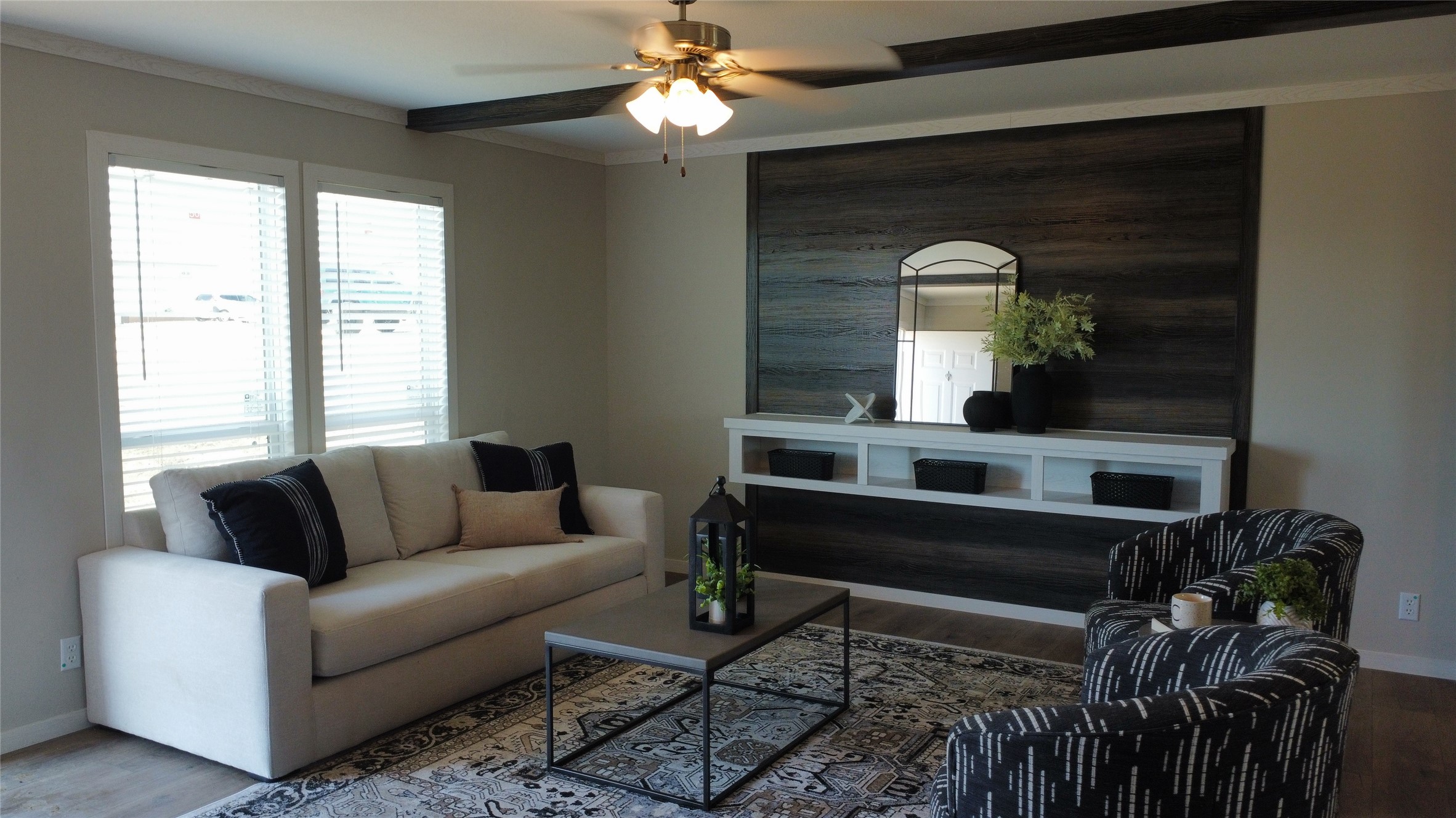 147 Ardales Drive Elgin, TX 78621 - Photo 11 of 14 Living area featuring wood finished floors, ceiling fan, ornamental molding, and an accent wall