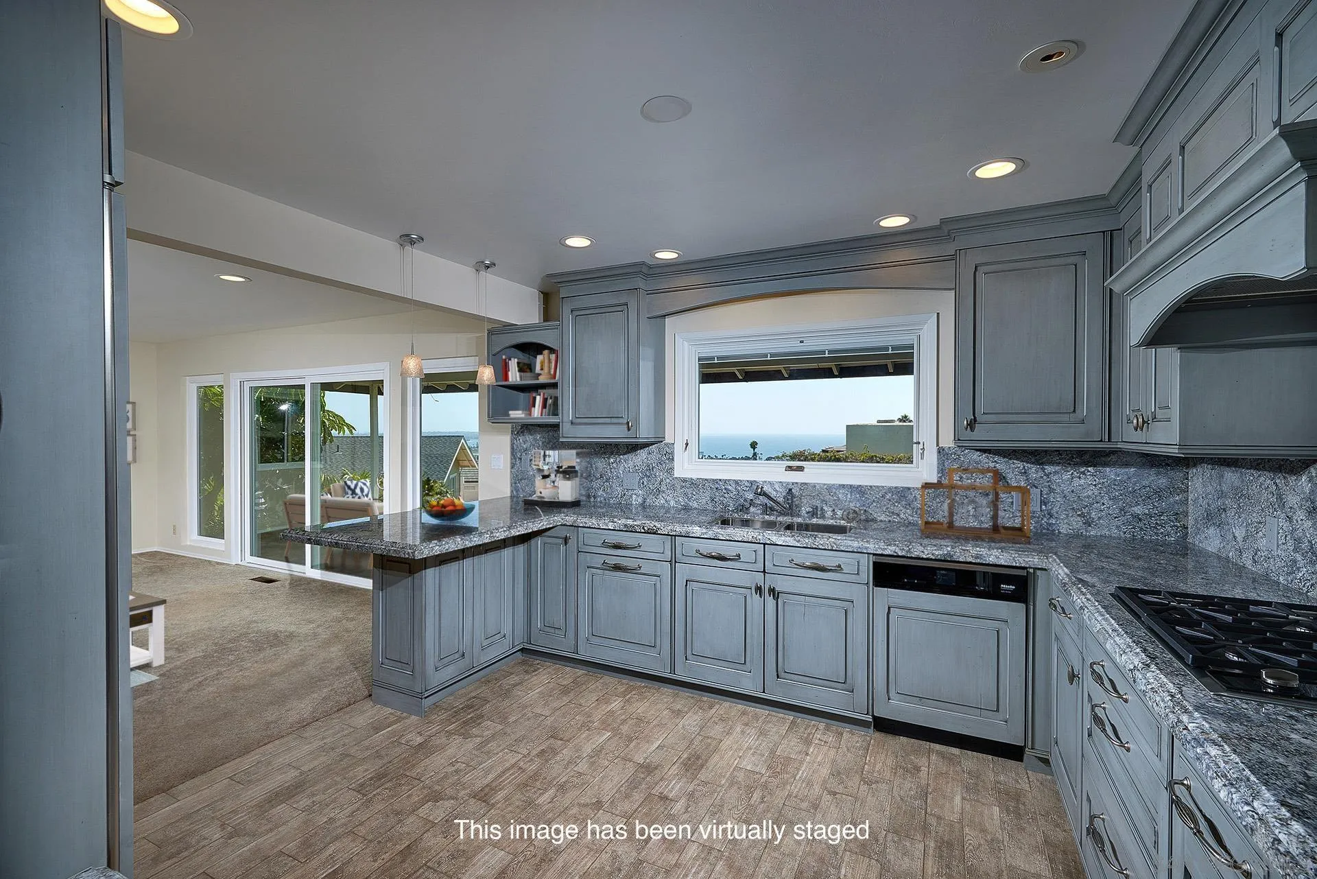 5560 Moonlight Lane La Jolla, CA 92037 - Photo 23 of 48 a kitchen with granite countertop sink stove and cabinets