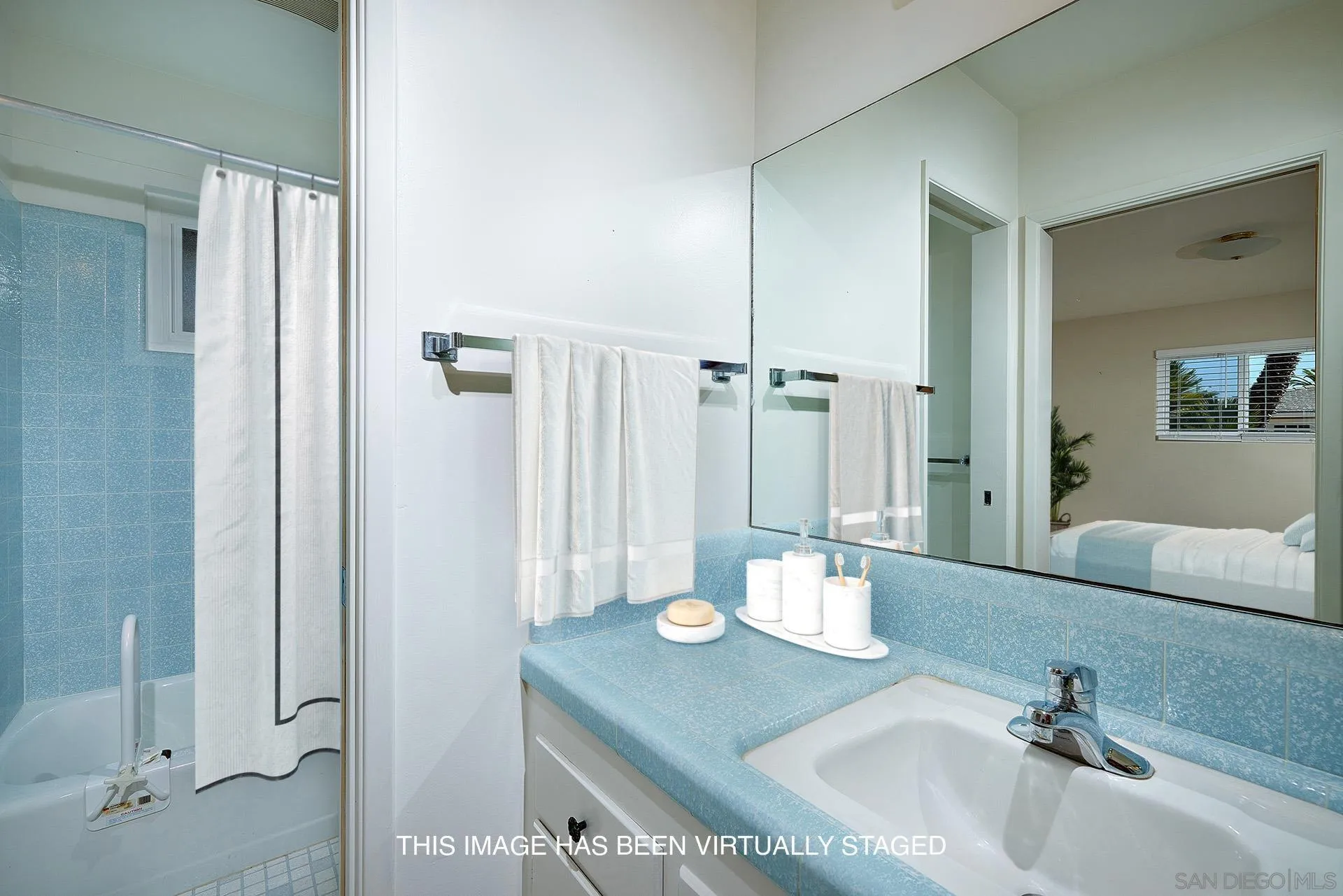 5560 Moonlight Lane La Jolla, CA 92037 - Photo 31 of 48 a bathroom with a granite countertop sink a mirror and a shower