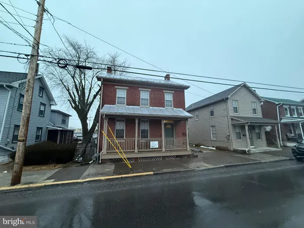 a front view of a house with a road